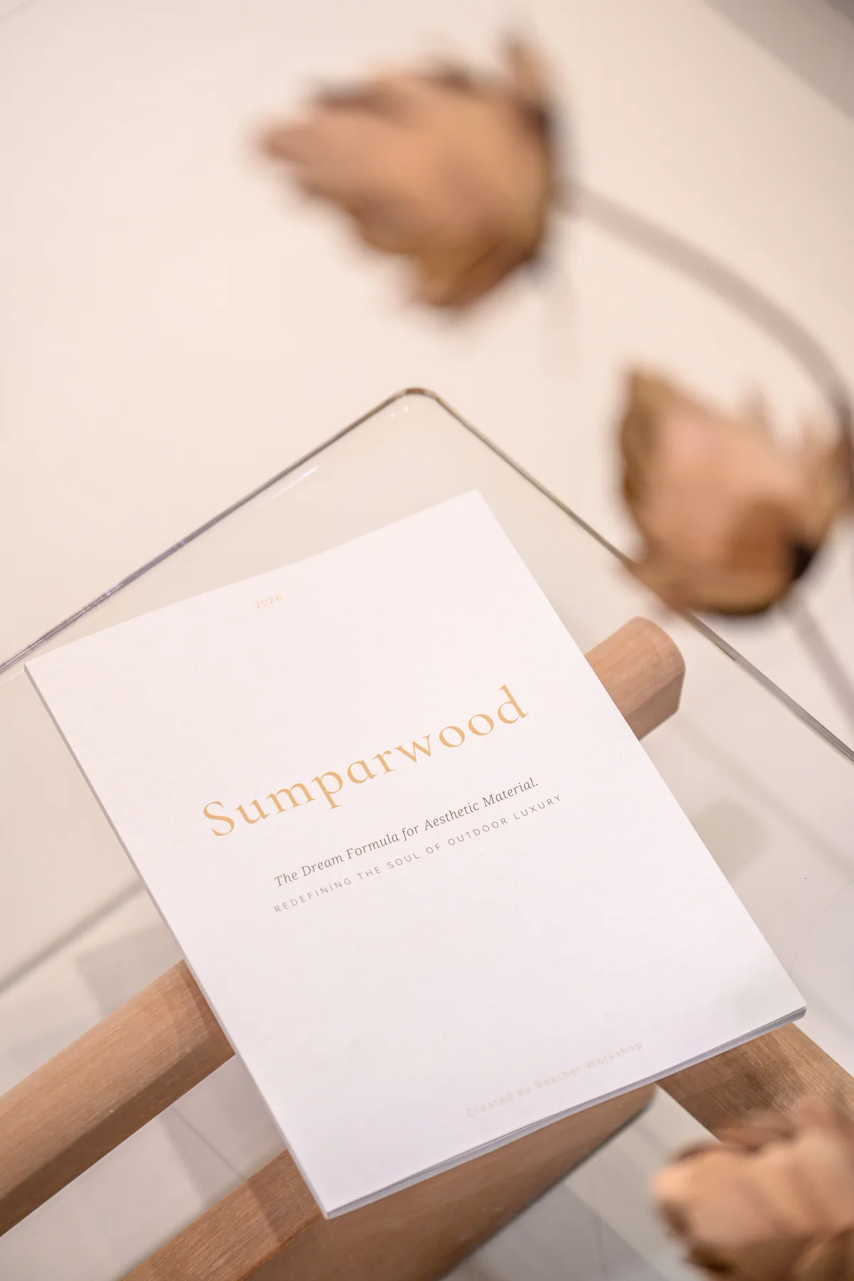 The 2026 Sumparwood Lookbook resting on a glass-topped exhibition table