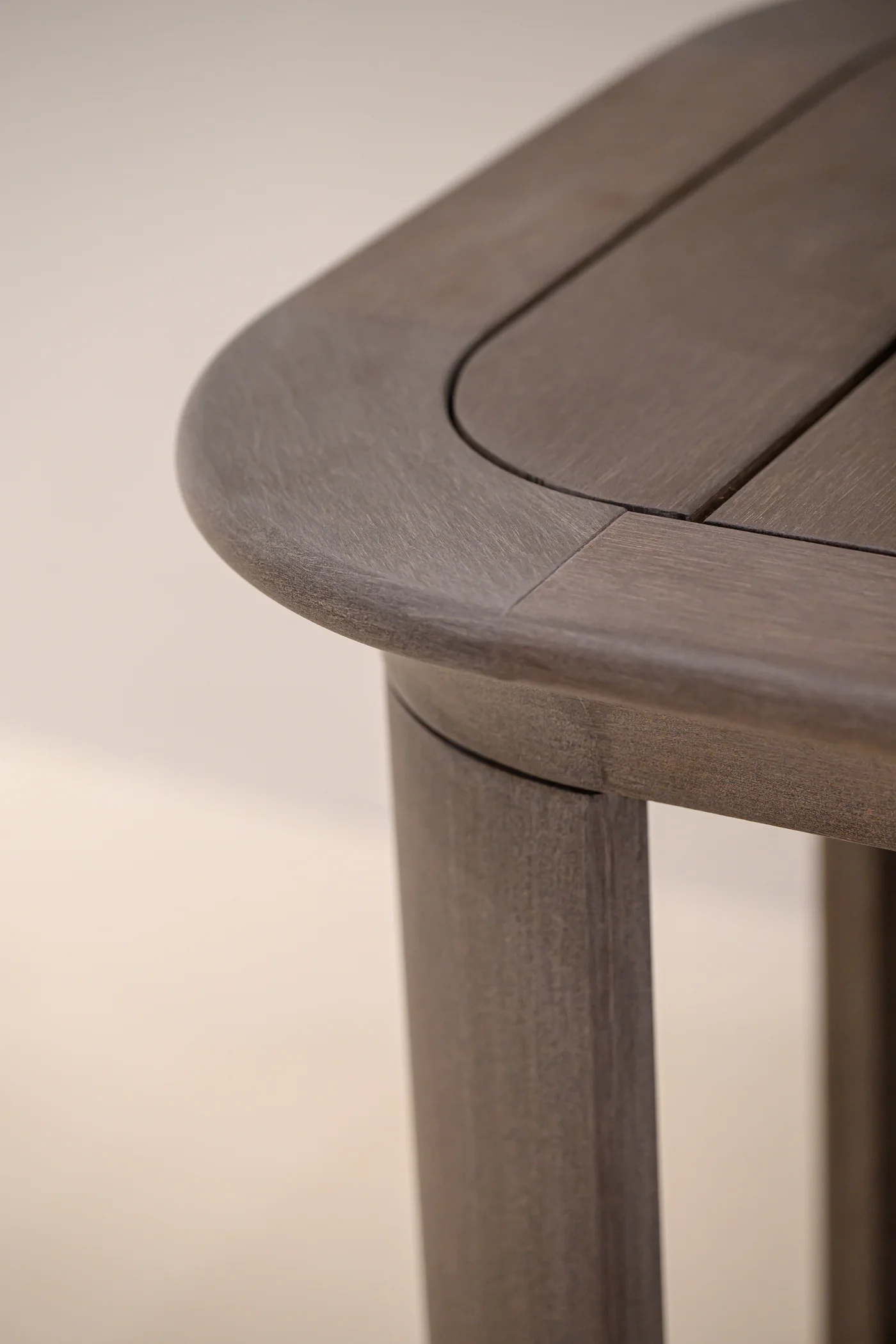 Rounded tabletop corner with inset panels above a leg