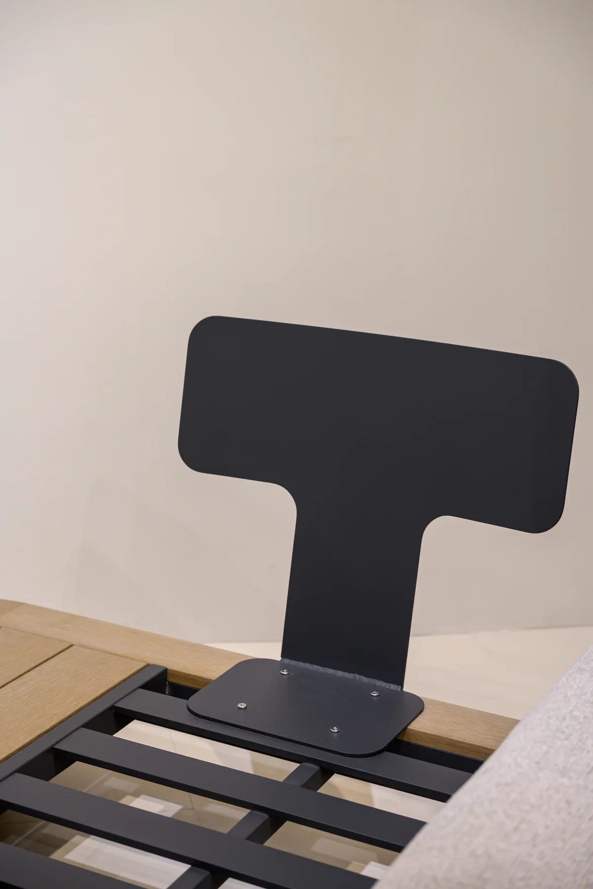 Exposed dark back support and visible fasteners above open seat rails