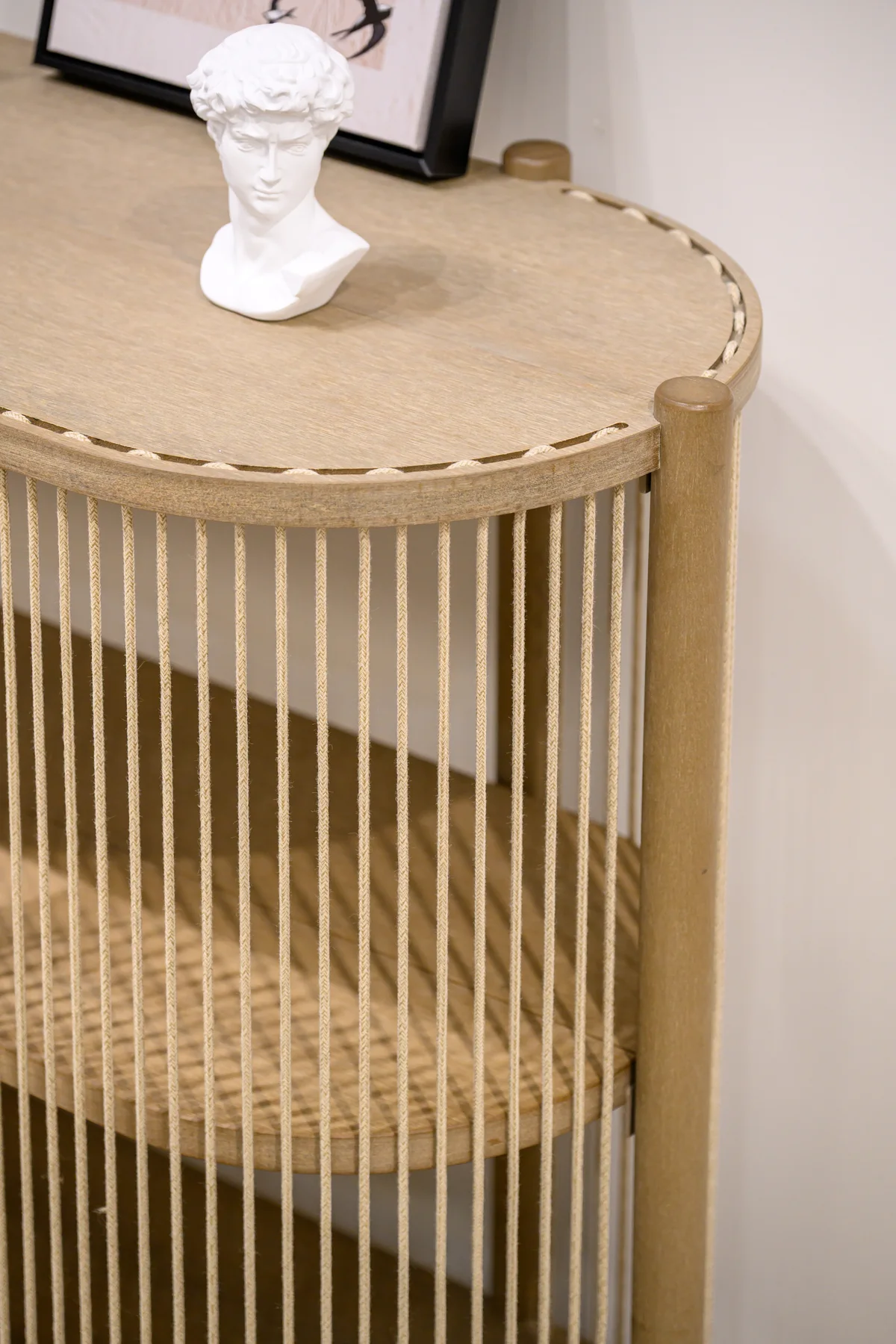 Round tabletop edge meeting a cylindrical upright and vertical woven cords
