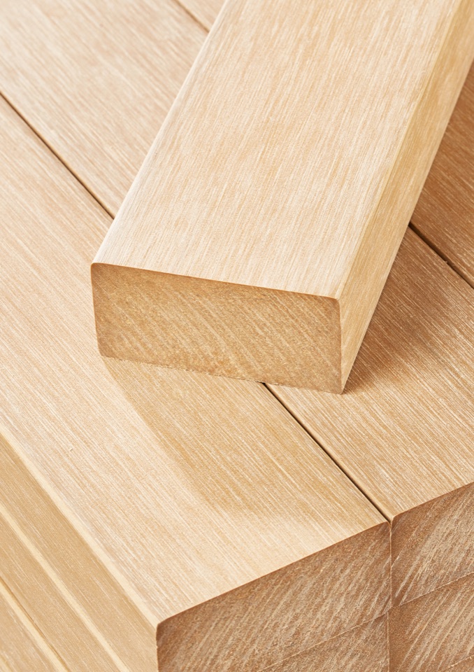 Close view of Sumparwood grain continuing across the surface and cut section.