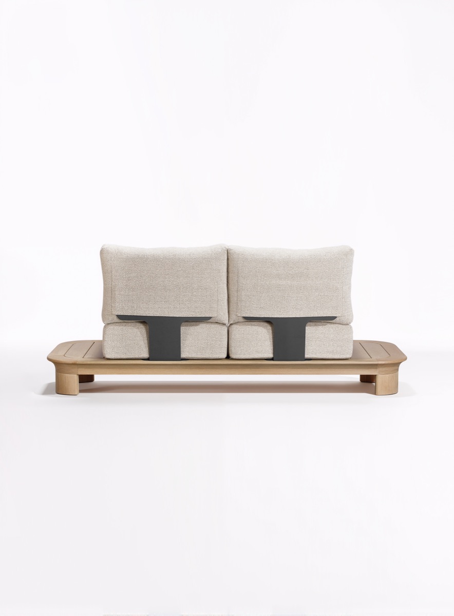 Back of an upholstered outdoor sofa showing its support structure and complete frame.