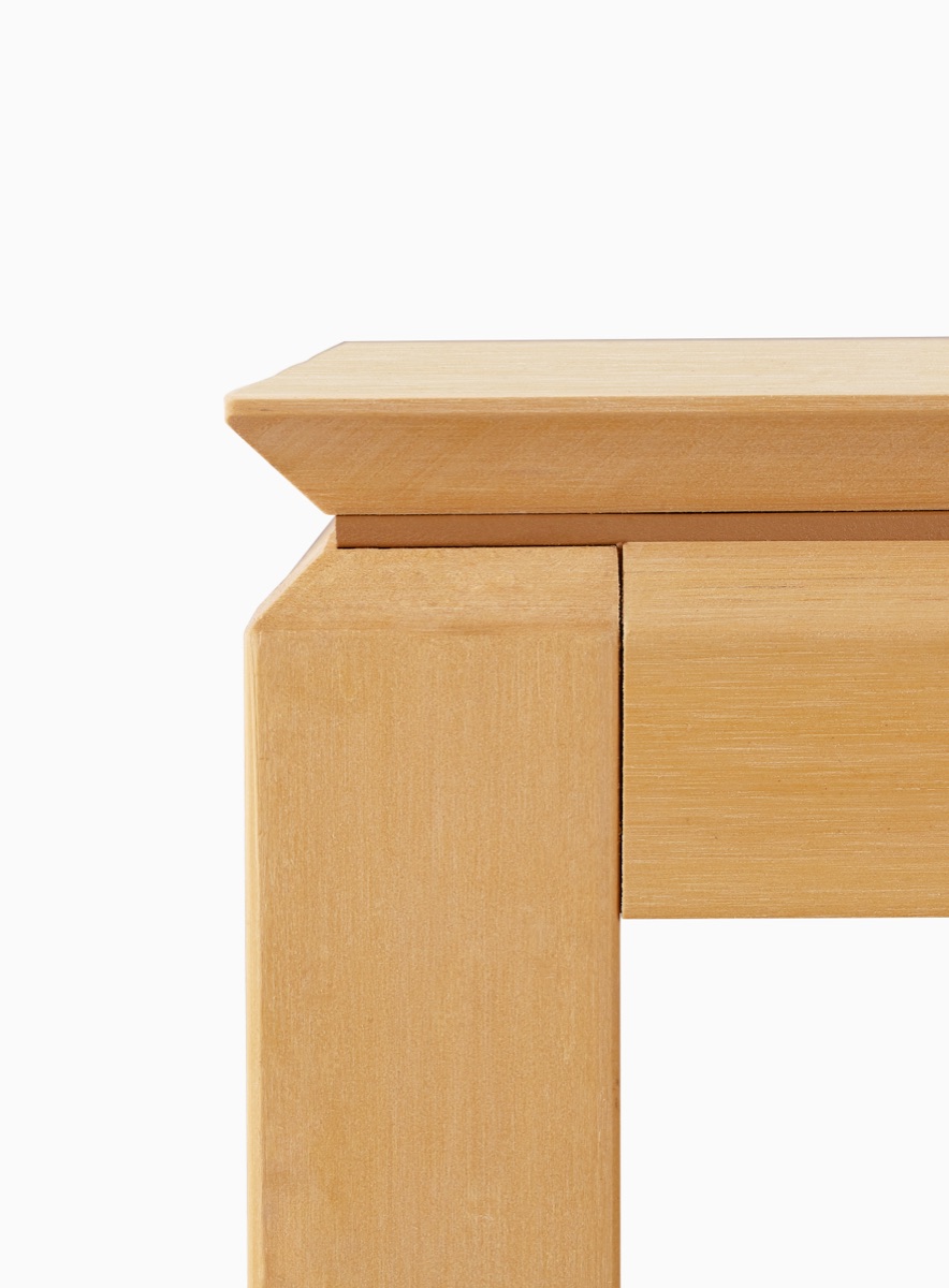 Close view of a formed tabletop edge meeting a leg and support section.