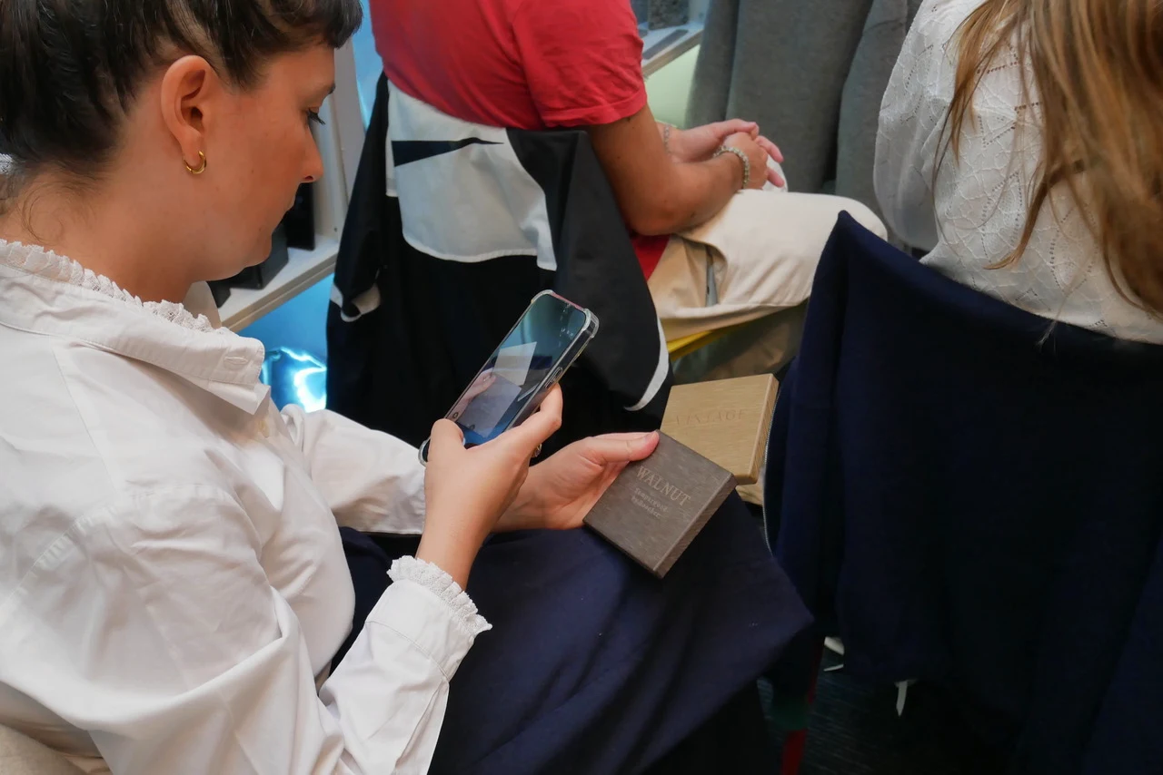 Attendee photographing two Sumparwood samples held together