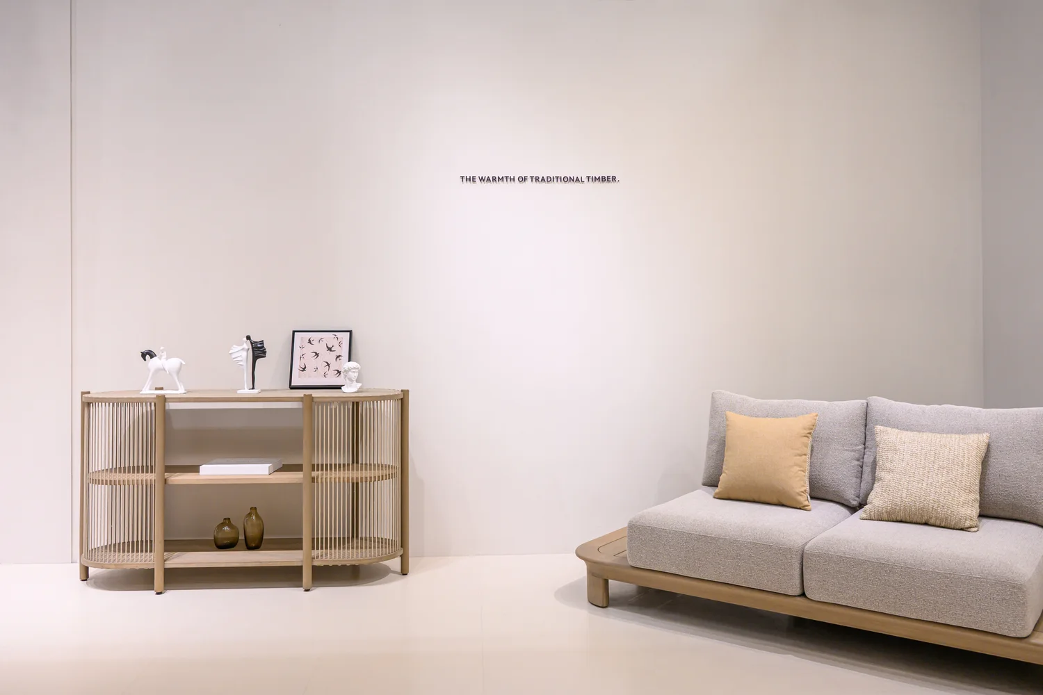 Sofa with divided seat and back cushions beside two loose pillows