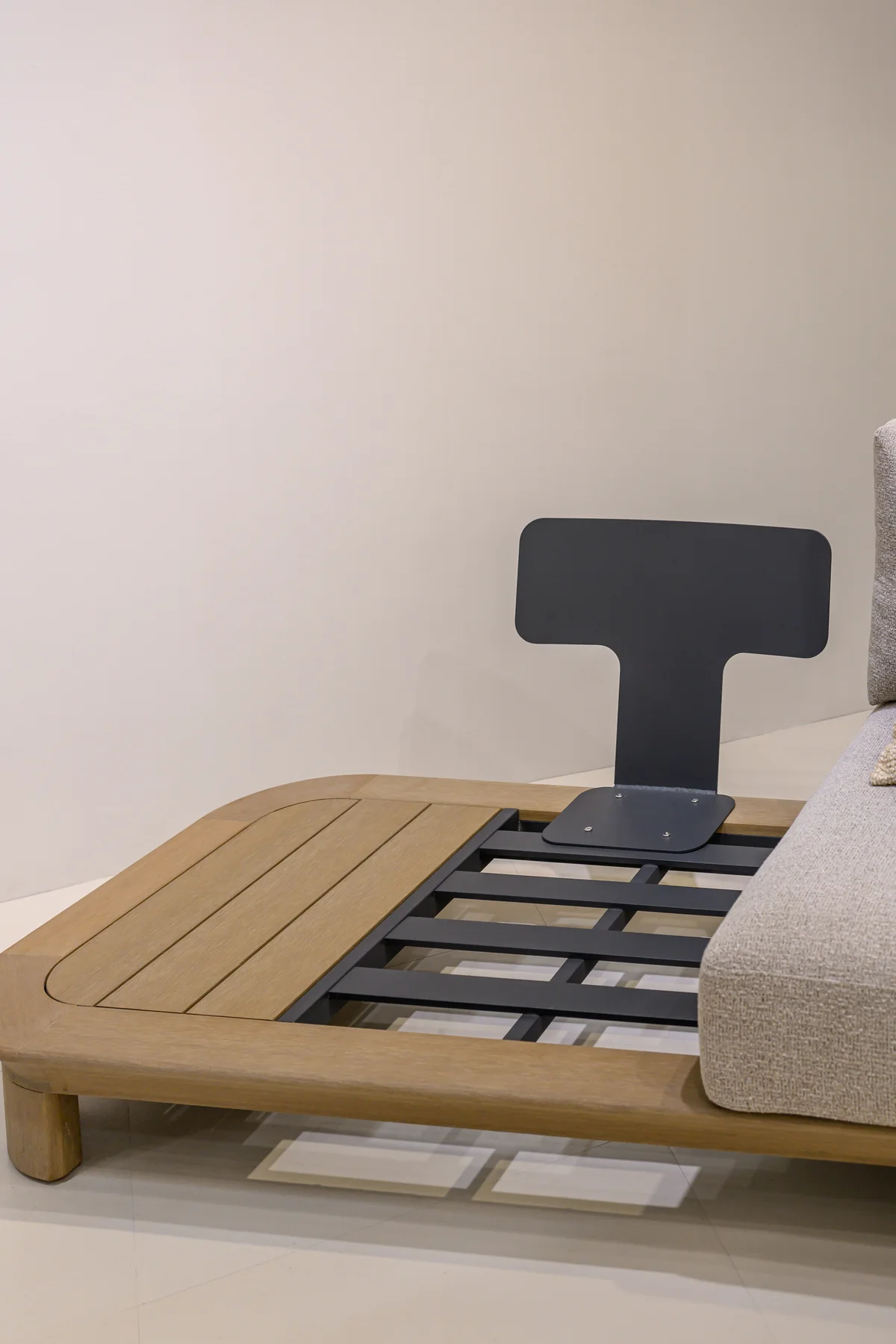 Lounger frame and cushion displayed indoors with the support structure exposed
