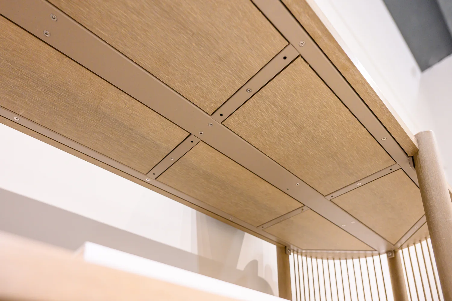 Underside of a tabletop showing perimeter members and inset panels