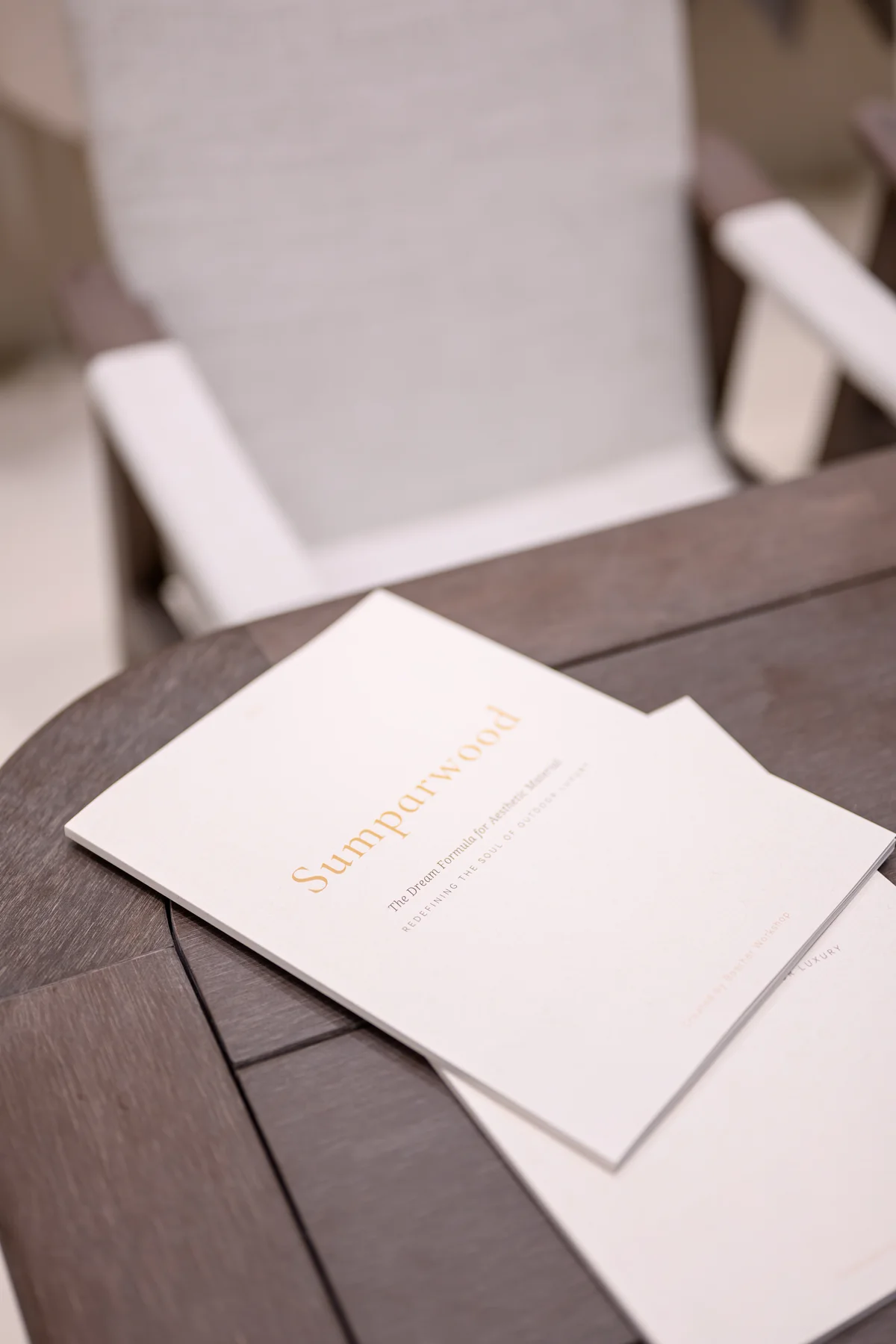 Printed Sumparwood information sheets resting on a dark furniture surface
