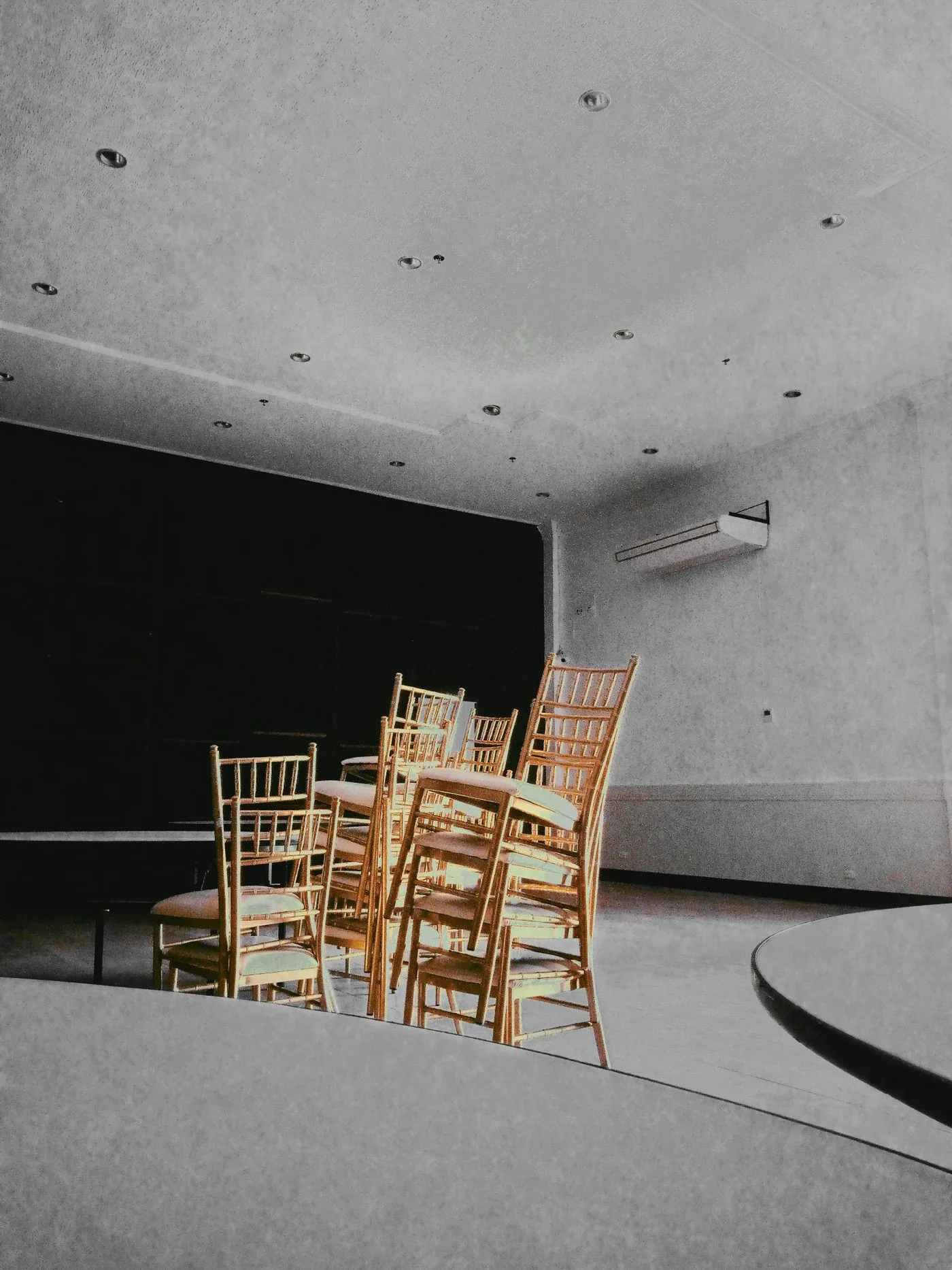 Stacks of banquet chairs in an indoor room between events
