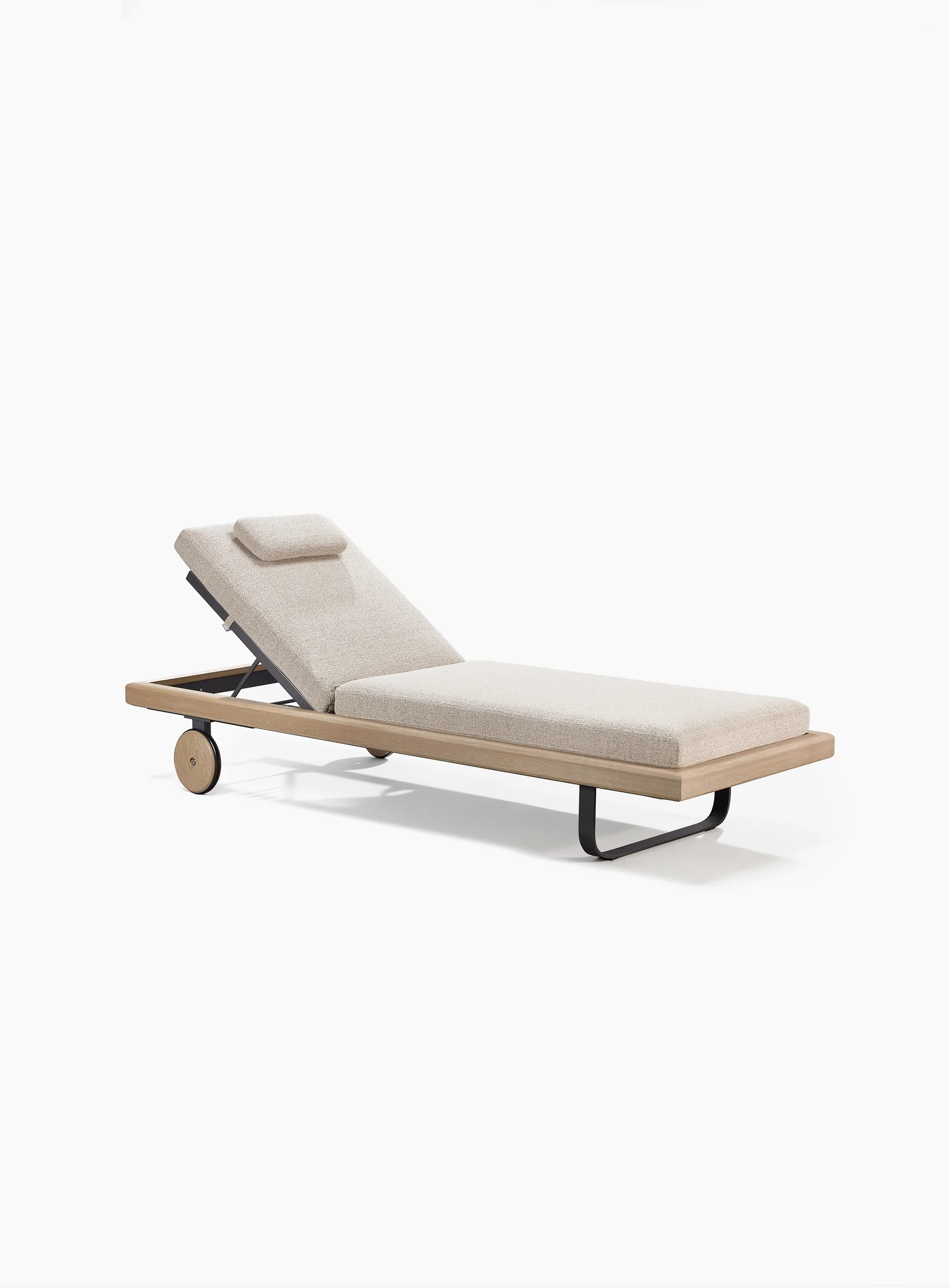 Opposite side of the lounger with raised upholstered back and head pillow